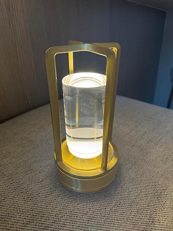 Customer photo: the gold crystal lantern on a fabric seat.