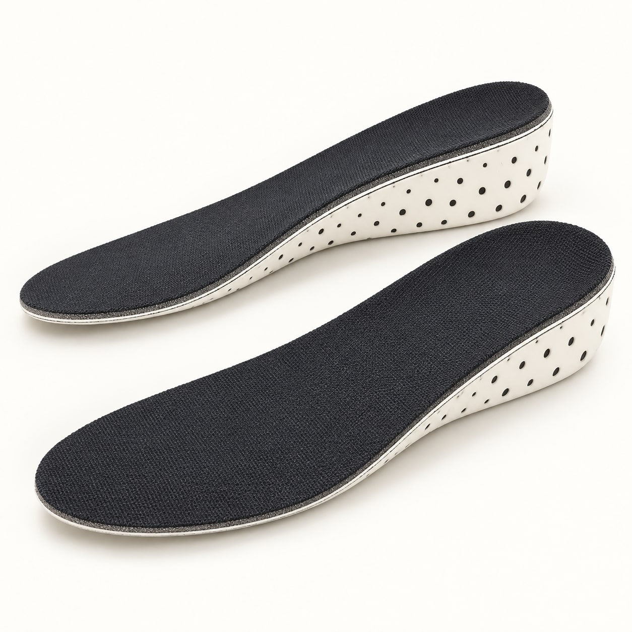 One pair of full-length height insoles, with black fabric from heel to toe and cream perforated foam sides