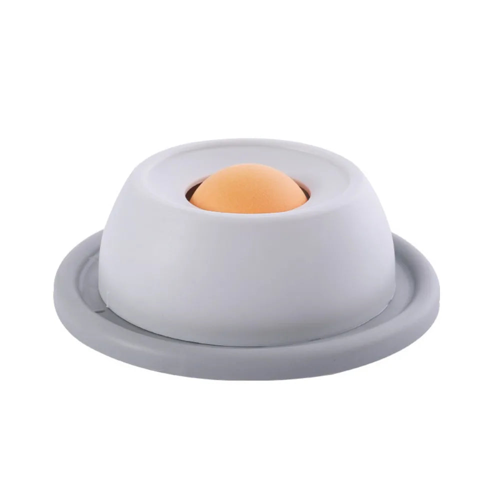 Grey bowl with a smooth orange rolling ball.
