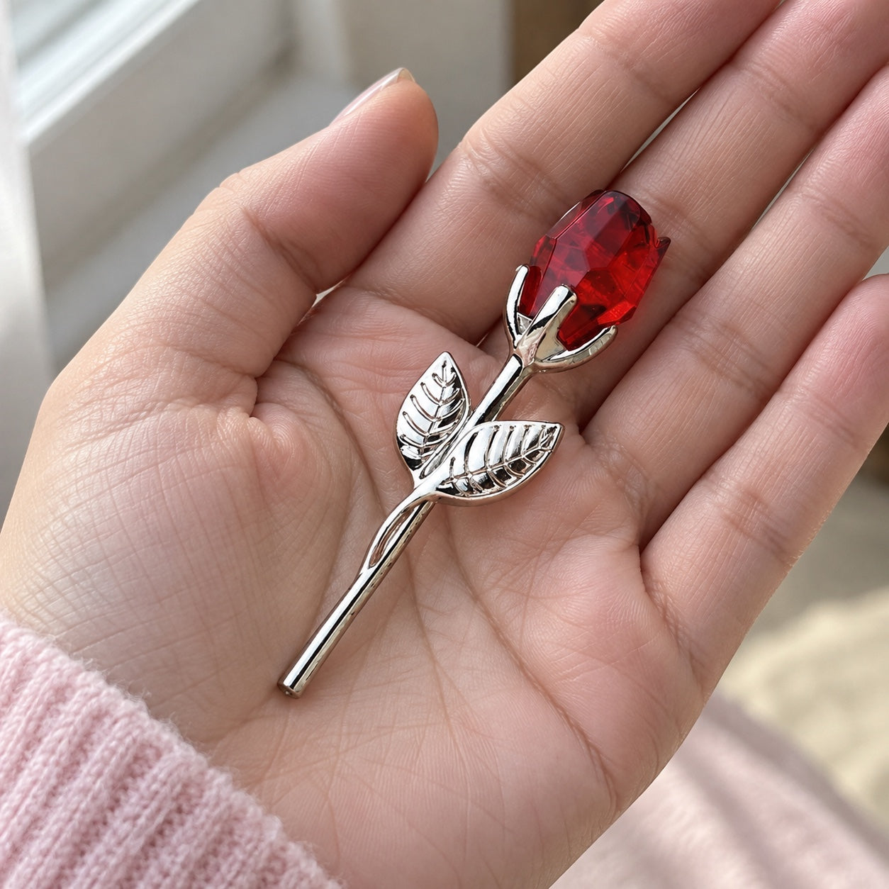 The complete 3.5-inch miniature crystal rose resting in an adult palm.