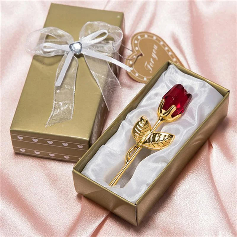 Close-up of the ruby crystal rose in its gold gift box.