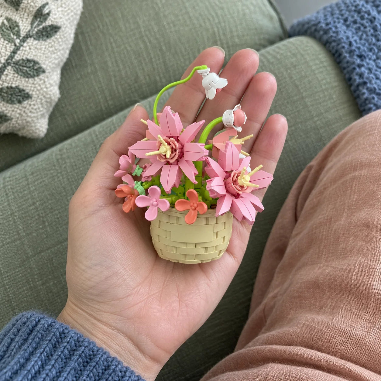Pink Petals resting in a palm for scale.