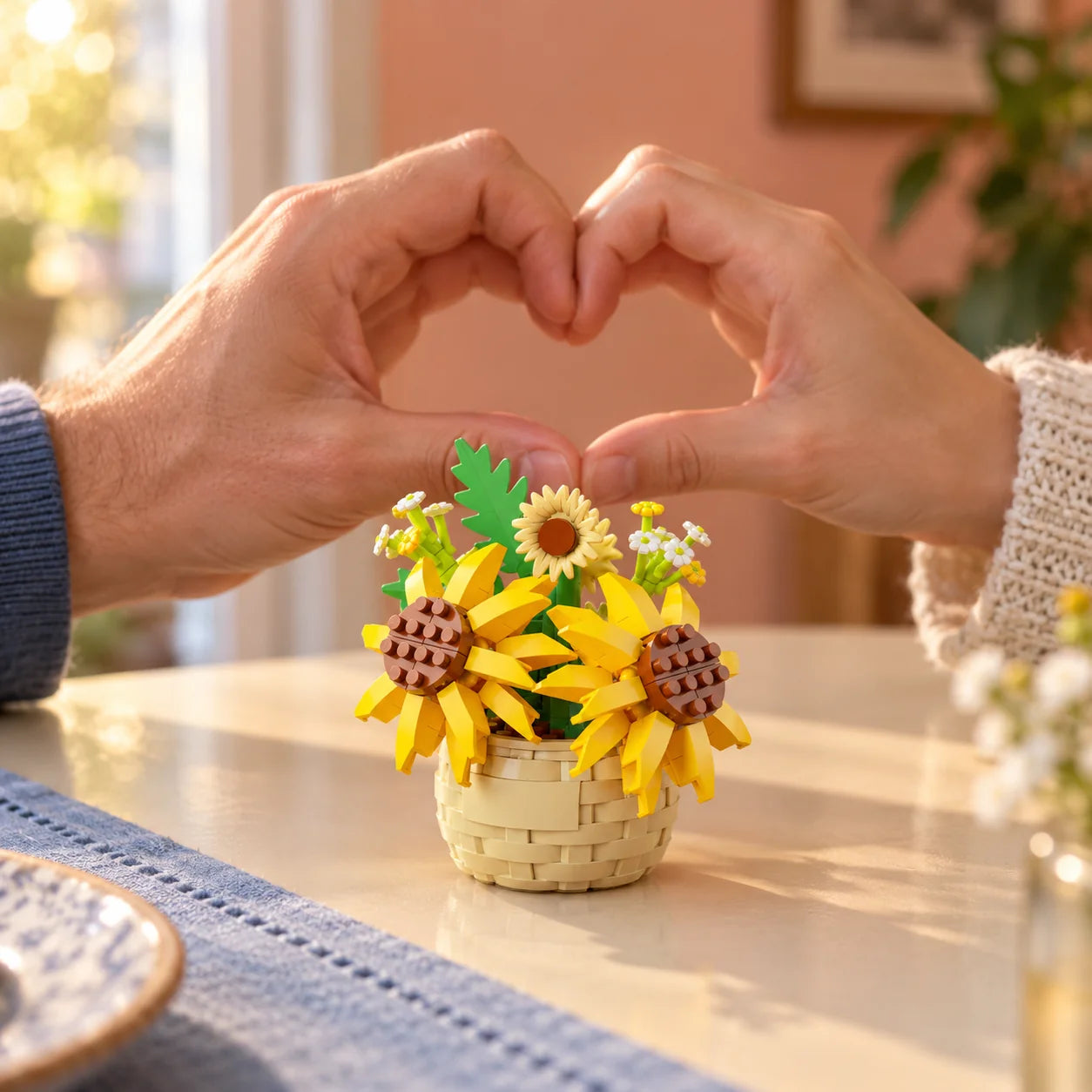 Sunshine mini flower in front of two hands forming a heart.