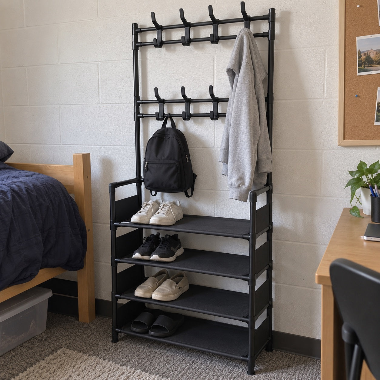 the black rack beside a dorm-style bed and desk, with a grey hoodie, black backpack and everyday shoes.
