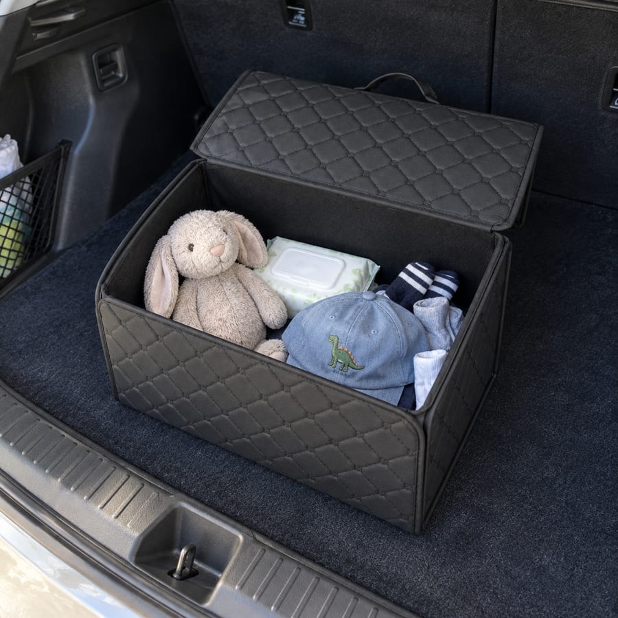 Open organizer holding small toys, socks and wipes in a family car.