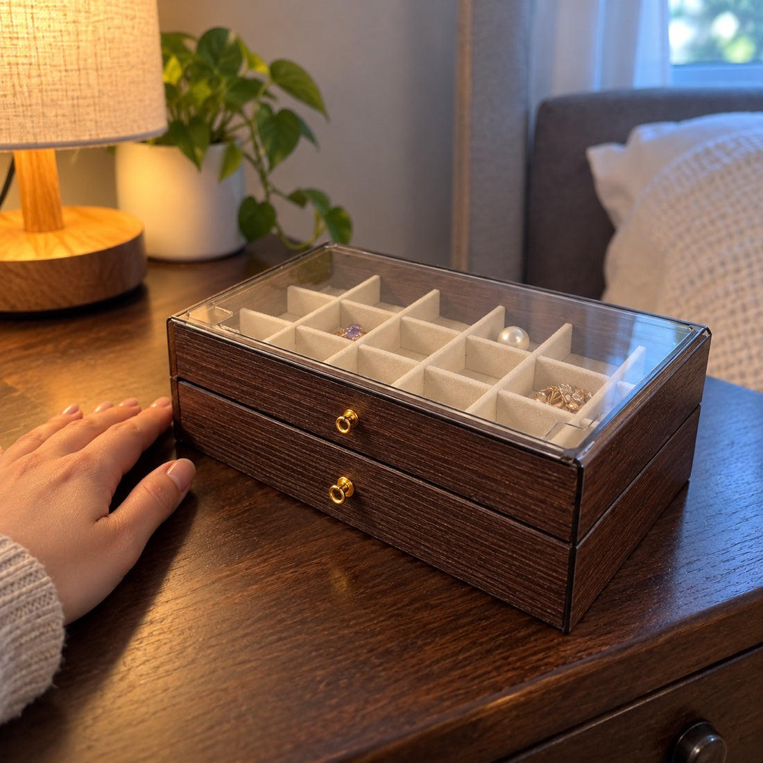 Closed jewelry box with a hand for scale.