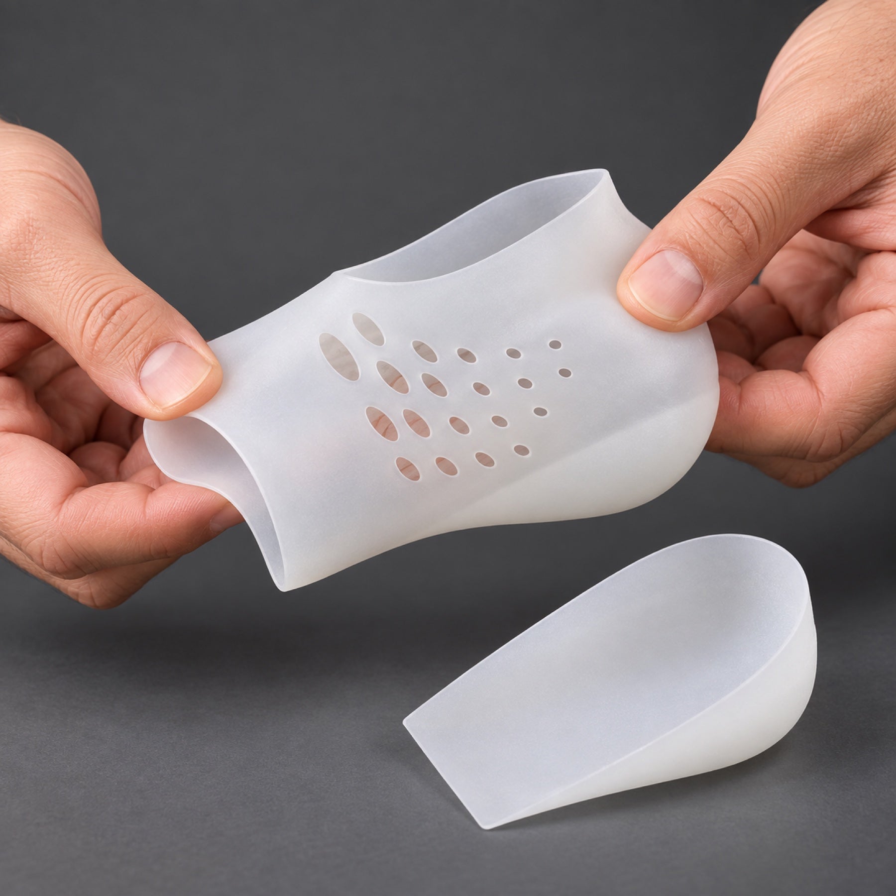 Hands flexing the soft translucent silicone heel sleeve