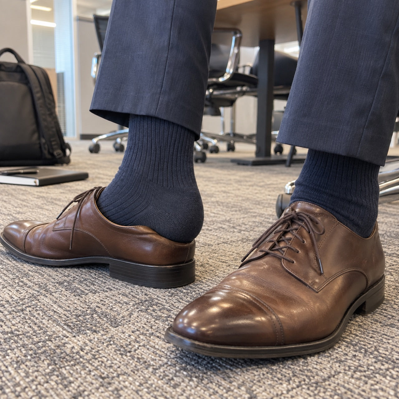 Customer photo of dark socks and brown dress shoes in an office