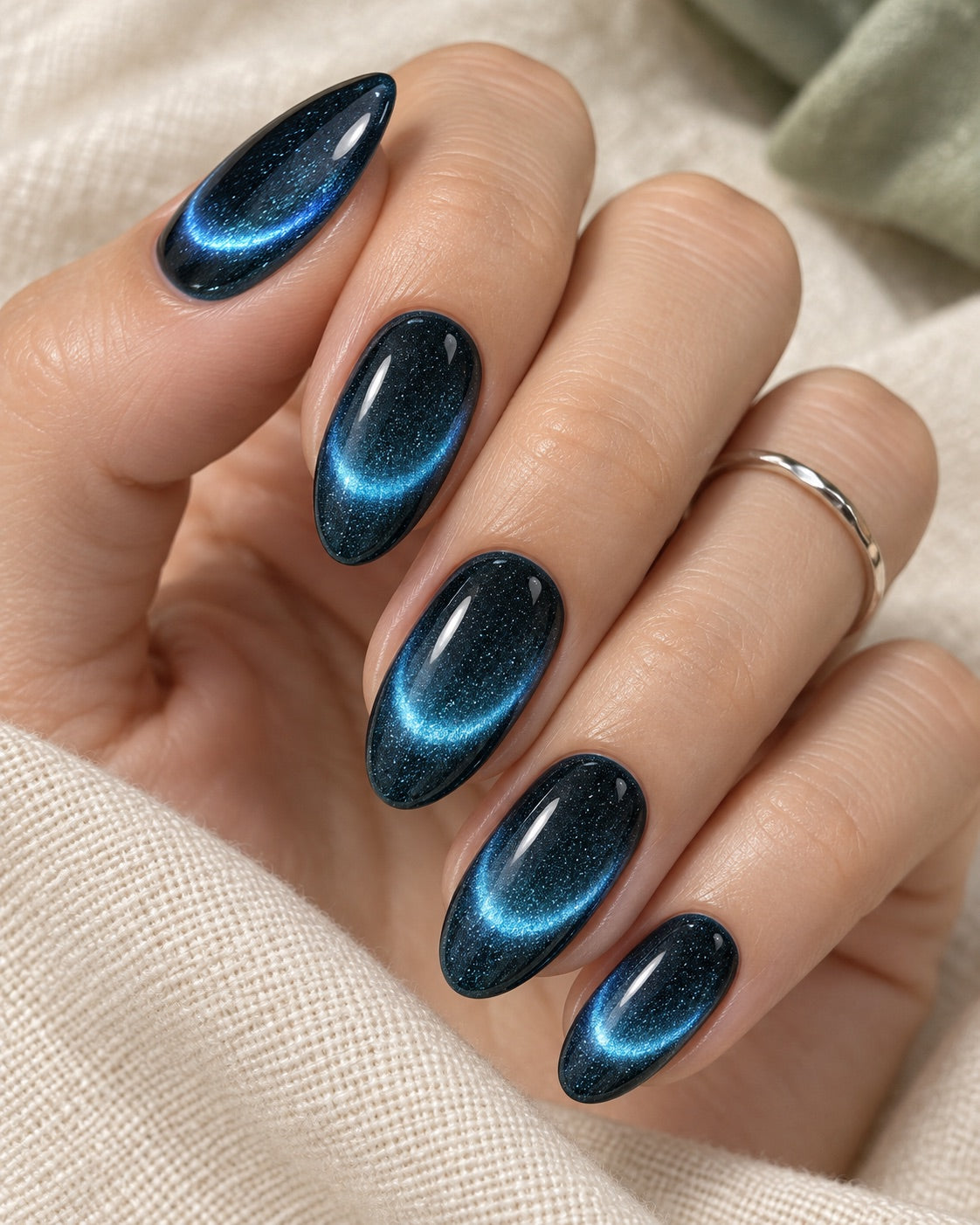 curved blue magnetic crescents on dark blue nails