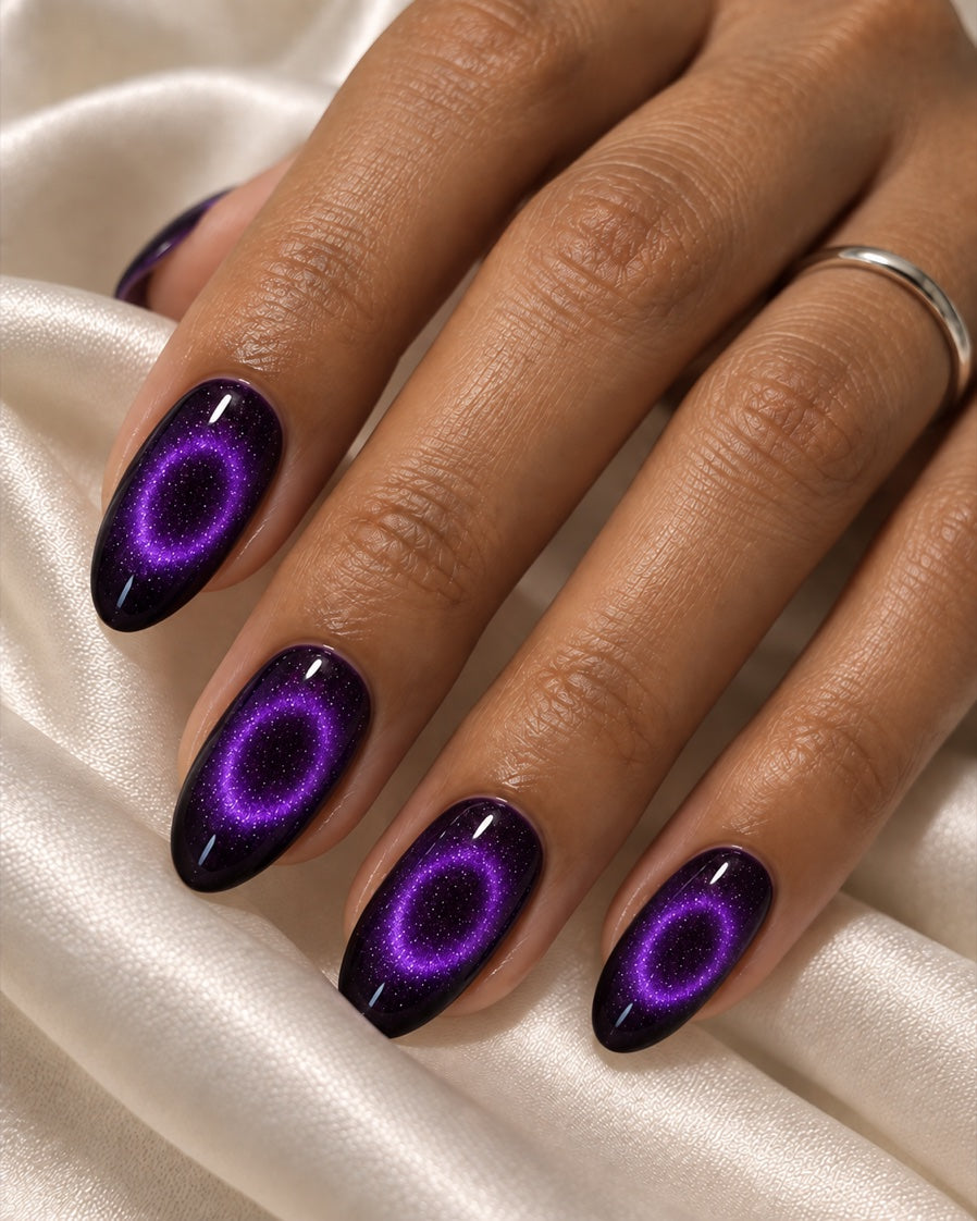 closed violet magnetic halo rings with dark centers on an adult hand