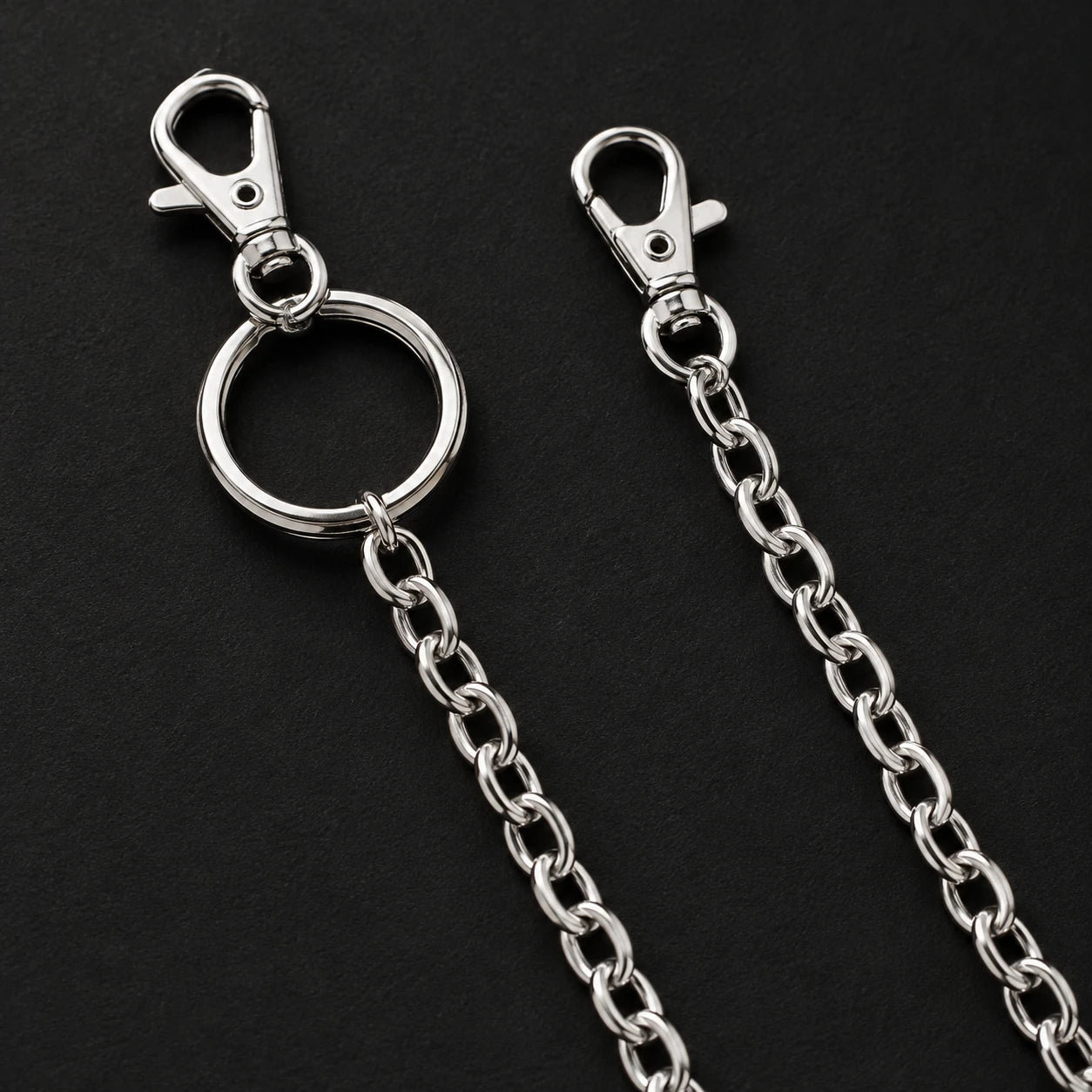 A chain end fittings showing two lobster-style clips and one larger ring