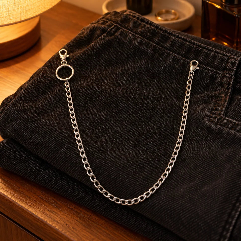 Single chain resting on folded denim