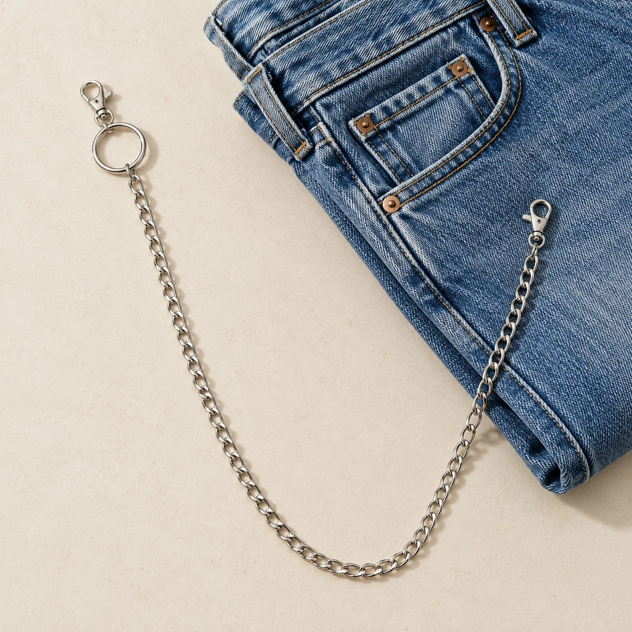 A single chain laid beside denim; written dimensions govern size