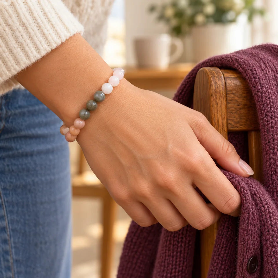 Self-Love bracelet on an adult wrist beside a plum cardigan and cream knit sleeve.