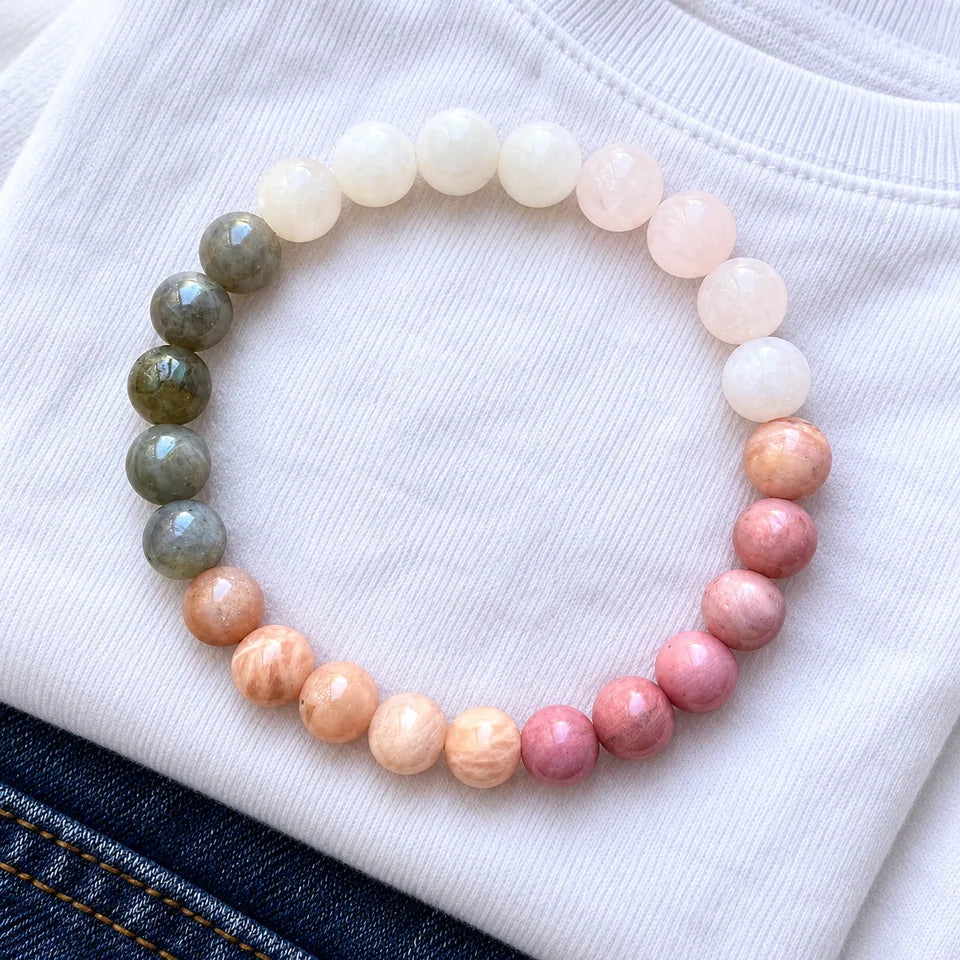 Self-Love bracelet lying on a folded white T-shirt with a dark denim corner.