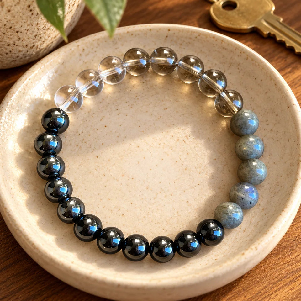 Grounding bracelet in a cream ceramic dish beside an entryway key.