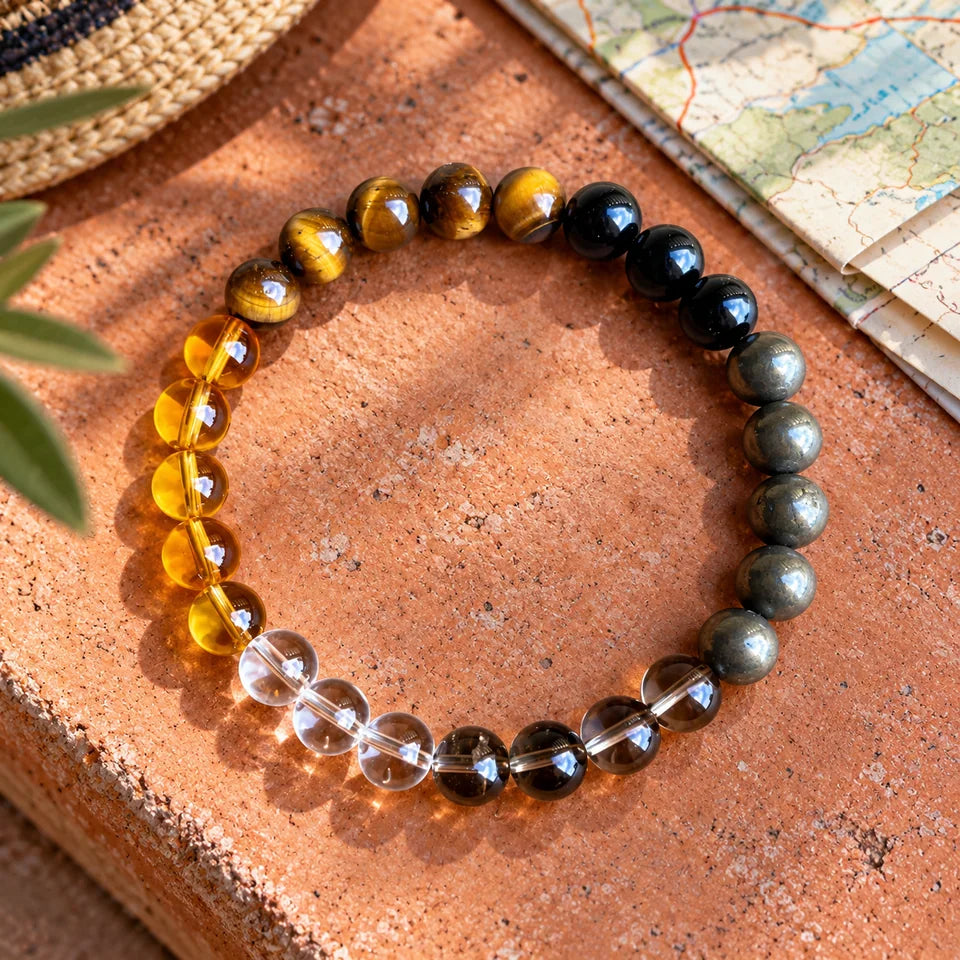 Road Opener bracelet on a terracotta tile beside a folded map.