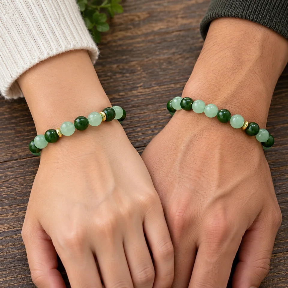 Two separate green bracelets worn on two adult wrists side by side.