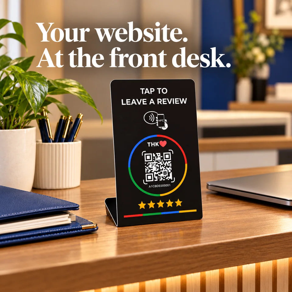 Stand on professional reception desk beside closed laptop and folders.