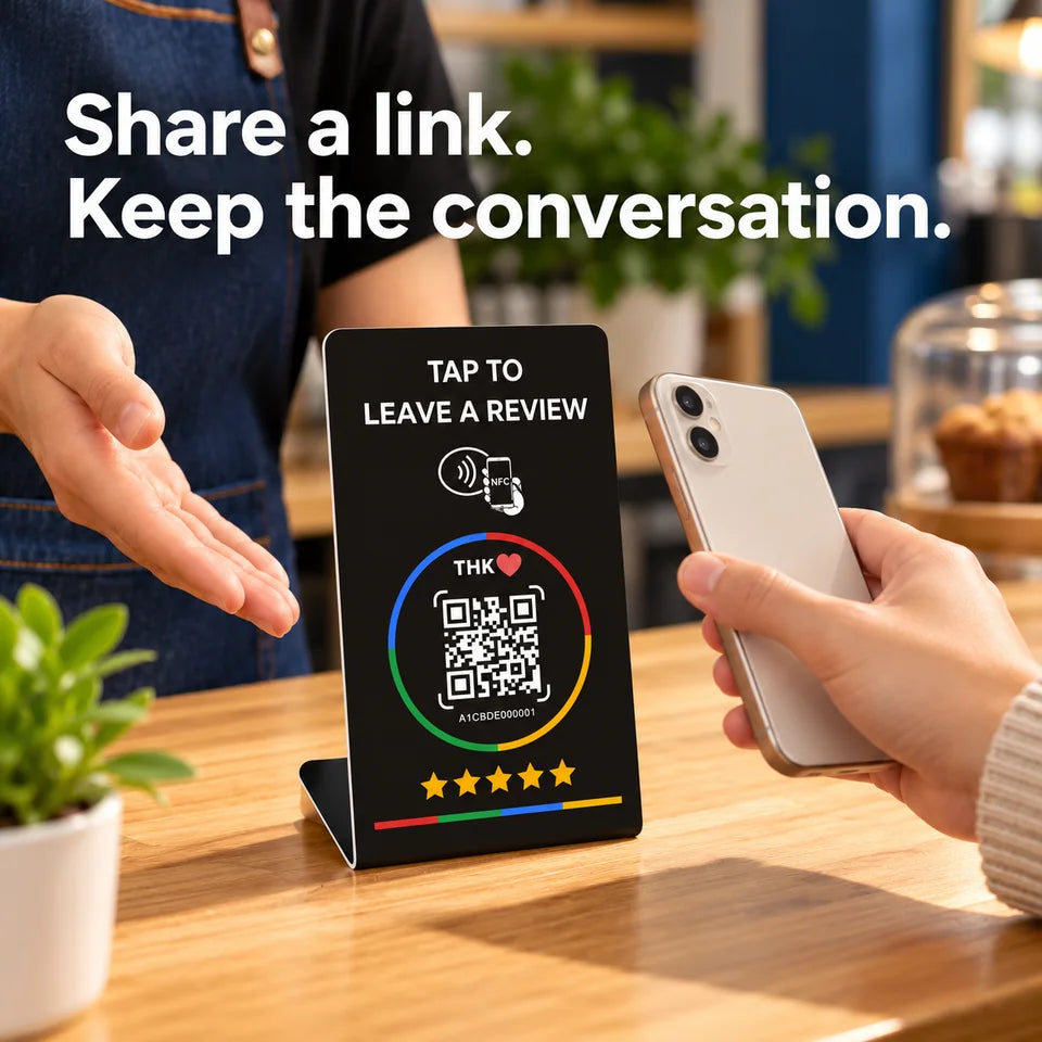Two hands around stand demonstrating a link-sharing moment with phone screen hidden.