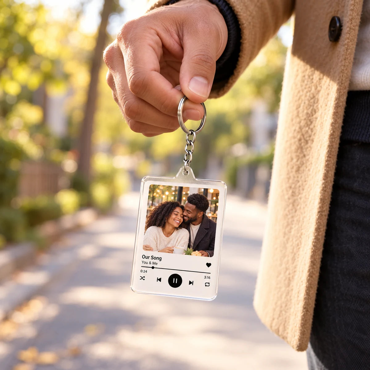 A single-photo keychain held at a realistic everyday size