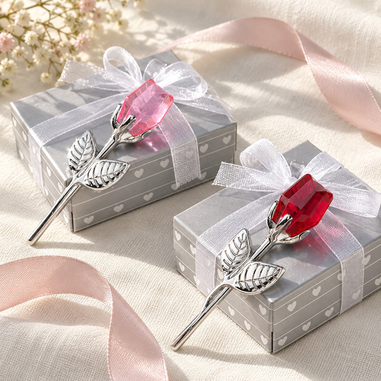 Two miniature roses with their individual gift boxes.