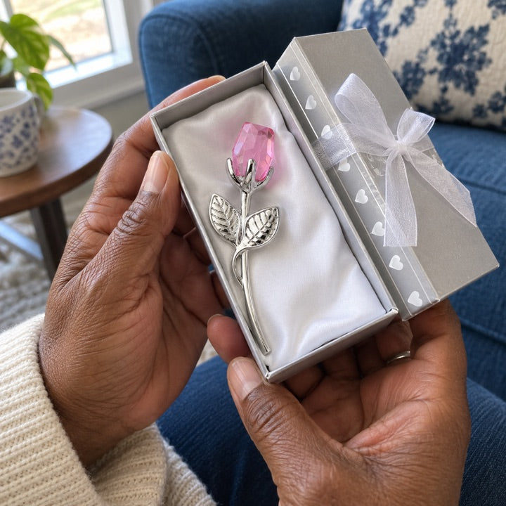 Open blush and silver rose box held in mature hands.