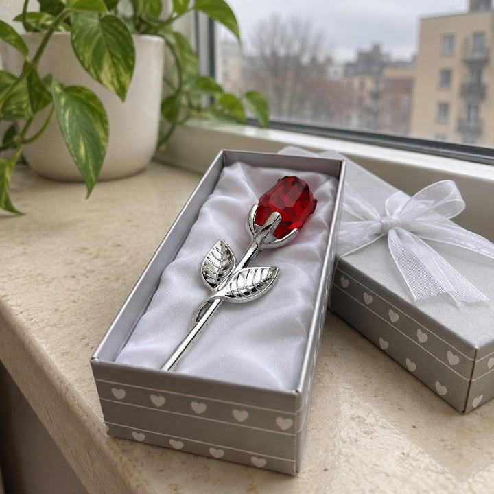 Ruby and silver rose box on a windowsill.