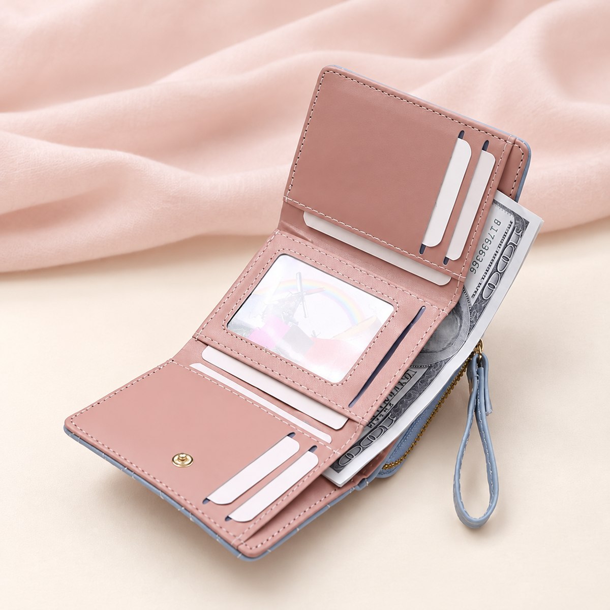Open trifold showing pink card slots, photo window and bill compartment