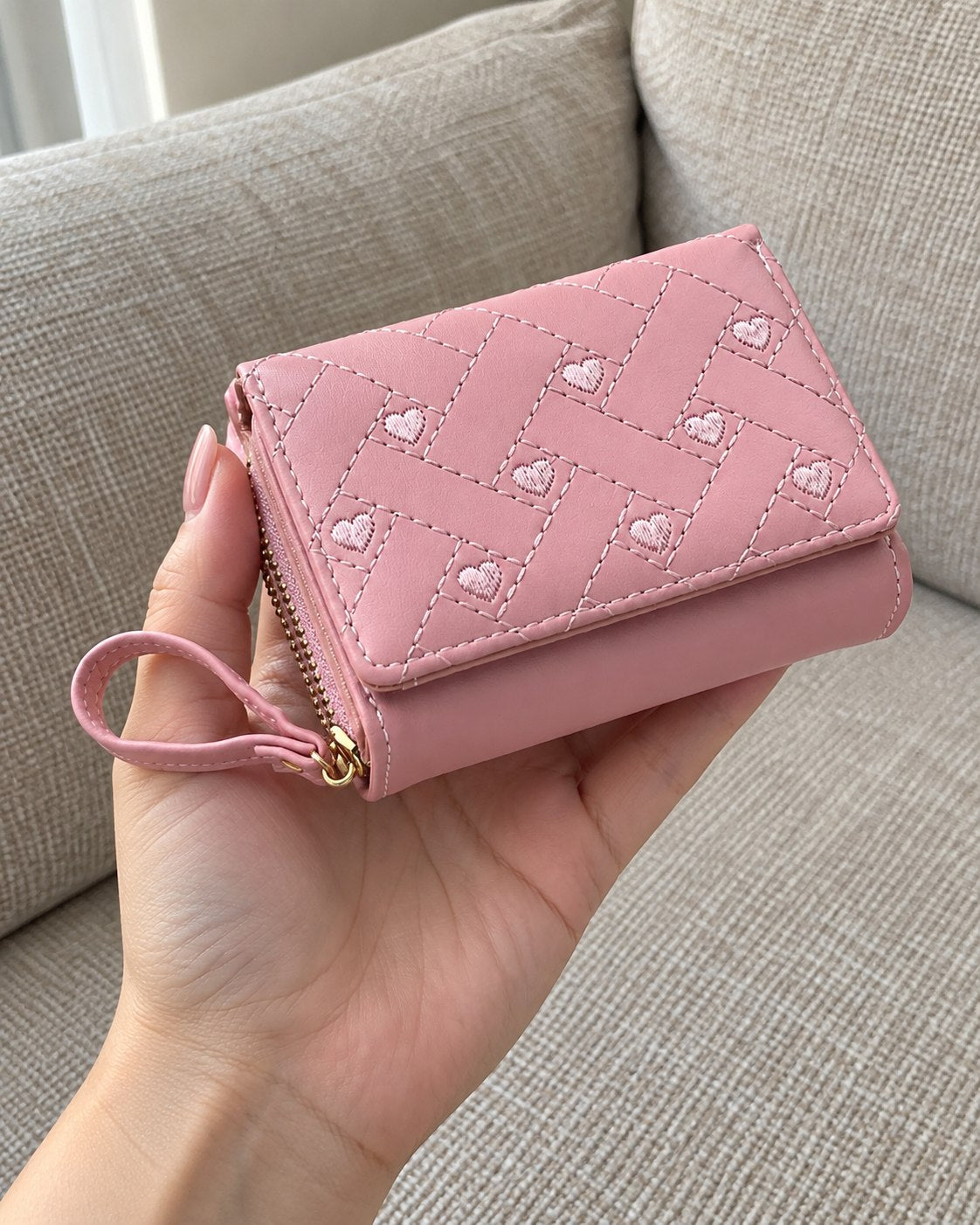 Photo of a rose wallet in a hand